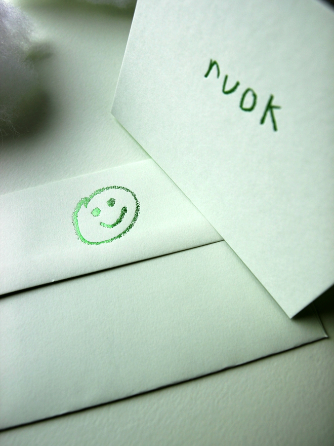 pistachio coloured card with ruok short for 'are you ok' hand foiled in kids hand writing