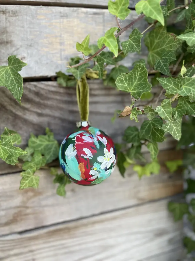  Unique hand-painted ceramic floral Christmas bauble featuring paper white flowers on a red background
