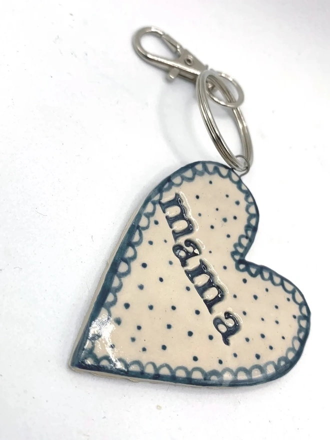 Mama Heart Ceramic Keyring, a blue keyring sitting on a plain white surface. 
