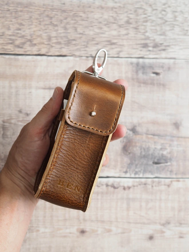 Personalised leather golf ball and tee carry case. A handmade leather pouch with clip personalised at the base with 3 letters.