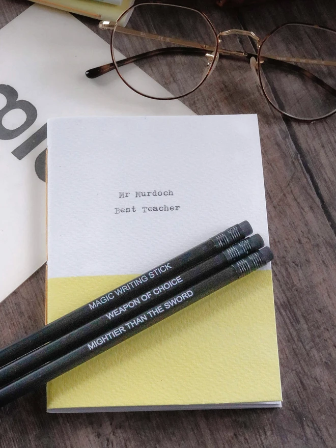 yellow and white personalised notebook with best teacher on the cover