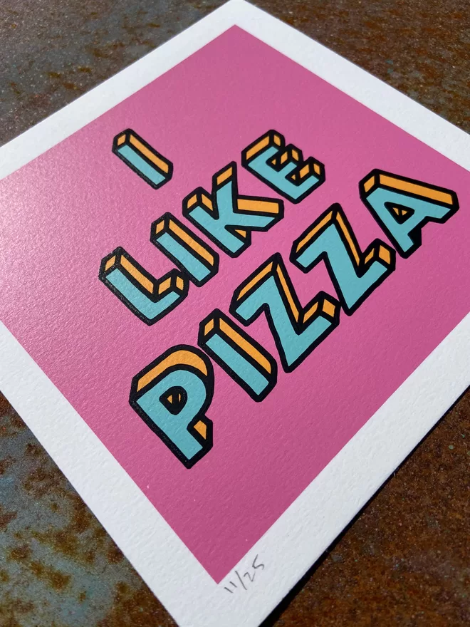 "I like Pizza" Mini Hand Pulled Screen Print square with pink background and the words i like pizza hand drawn and printed on top with black outline to the letters 