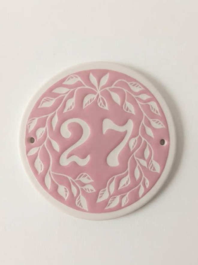 Custom Round Ceramic House Number with Leaves. A house number in pink.