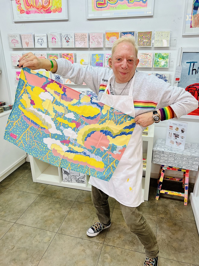Happy artist holding sure azure can be 100% organic charity cotton tea towel clouds & thunder