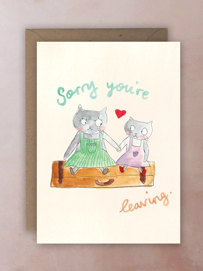 Two cats sat on a suitcase.