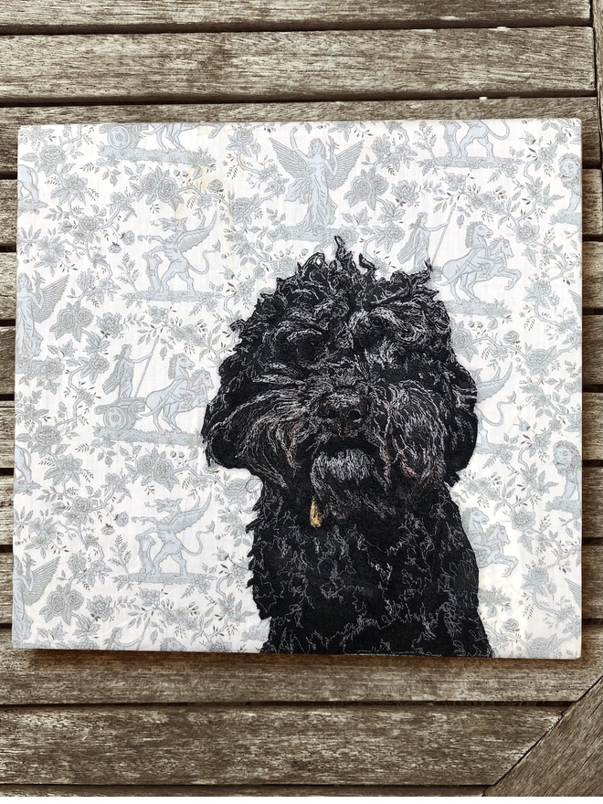 photo of a embroidered pet portrait of a black labradoodle