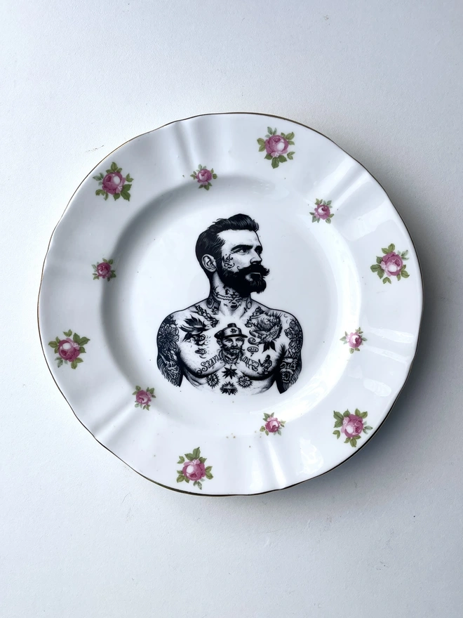 a vintage plate with ornate border, within the centre i have printed the vintage style image of a victorian tattooed sailor man