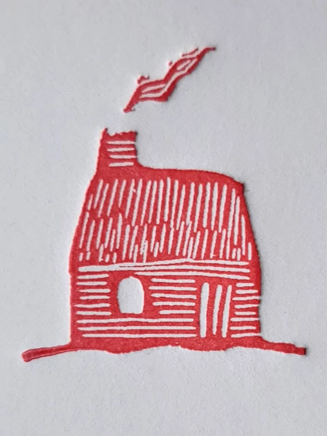 Tiny Red Cottage Letterpress Handprinted Greetings Card, a white card with a tiny red cottage design in the centre. 