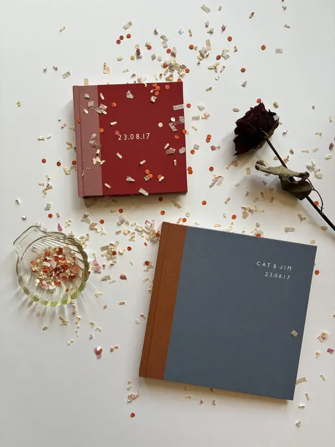 Confetti littered table with two handmade Keep Collect handmade instant photo guestbooks 