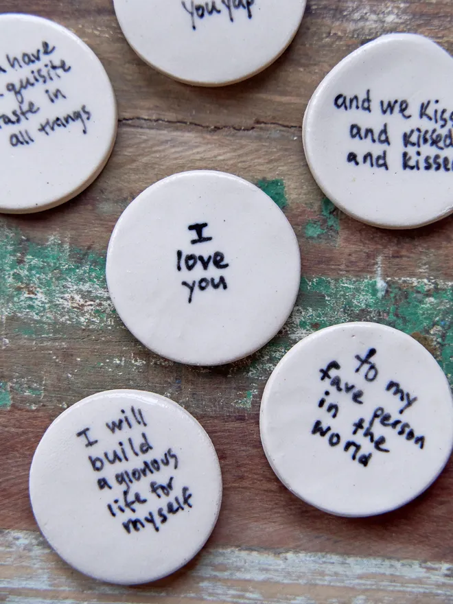 Small ceramic love token. A group of ceramic love tokens on a wooden surface