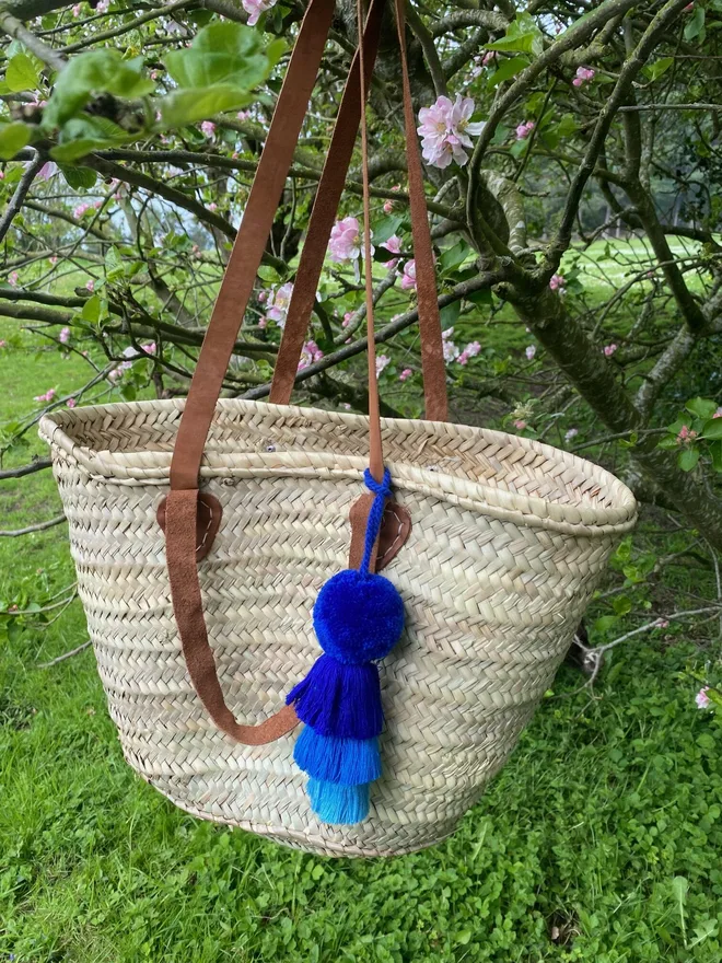 pom pom and tassel swag hanging decoration. a hanging decoration in shades of blue.