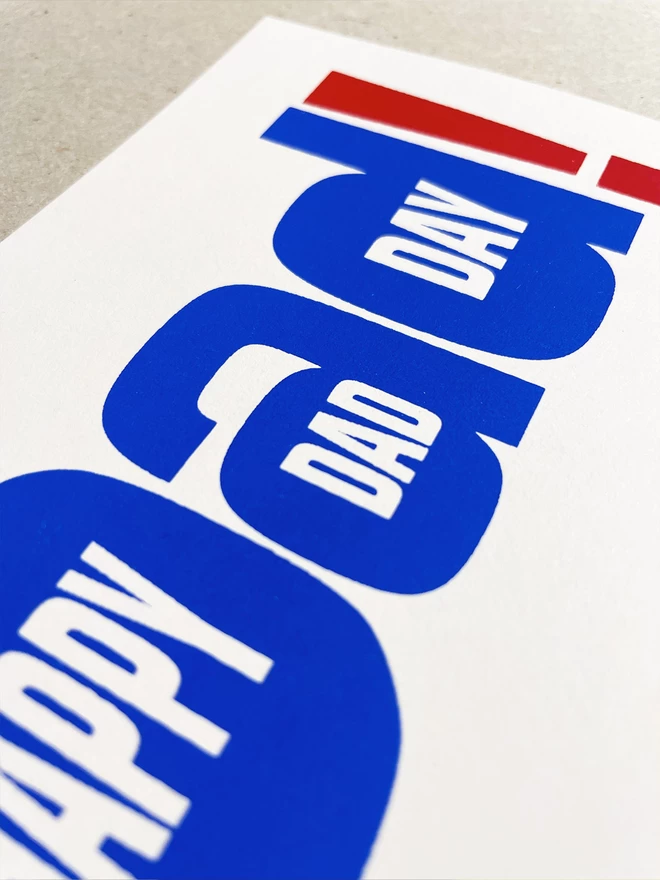 Close up of the text within text of the blue and red ink screenprinted greetings card.