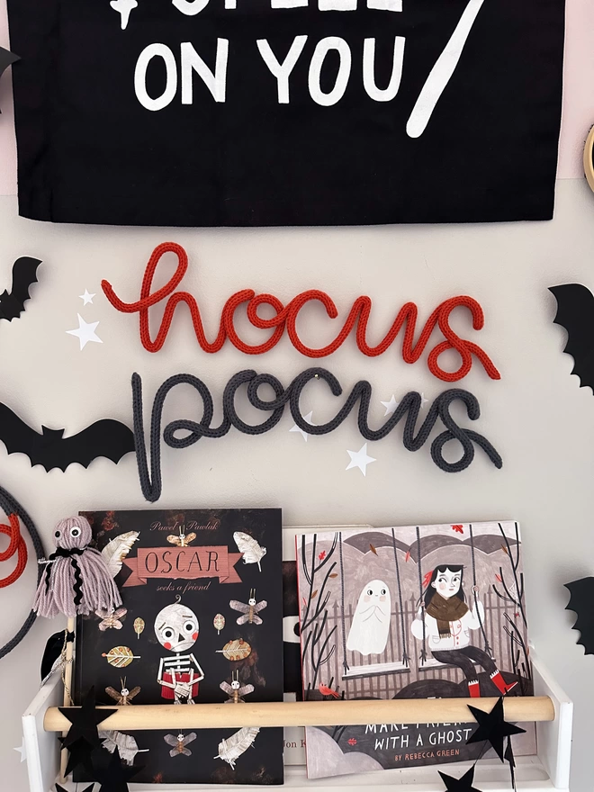 A 'Hocus Pocus' wall sign hanging up to decorate a child's play area. 