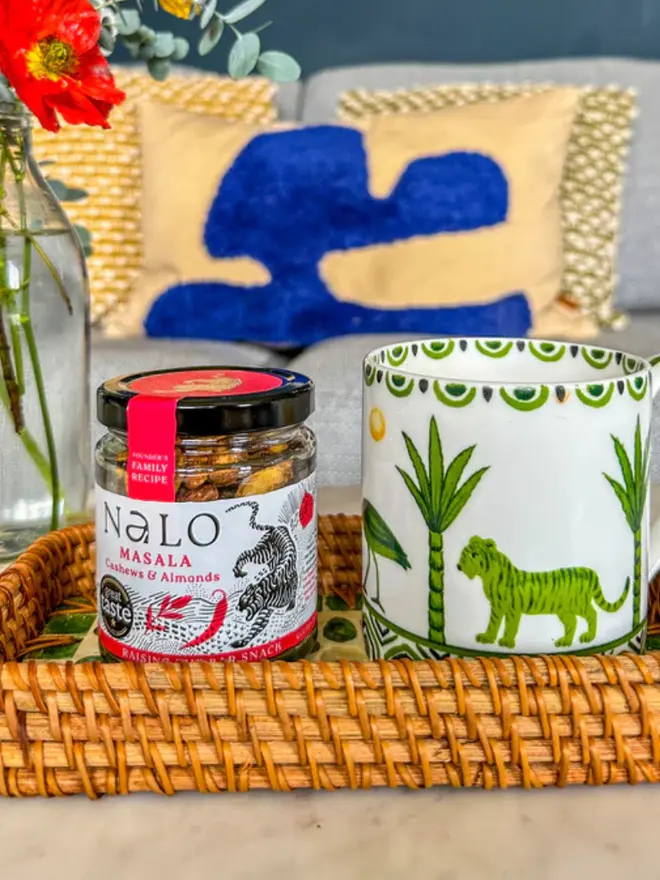 Masala Cashews & Almonds (Set Of 6), Displayed in a colourful basket, next to mug. 