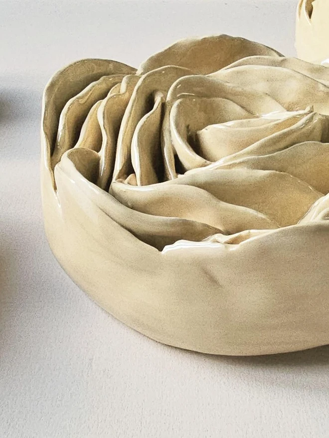 Cream handmade ceramic rose sculpture with a glossy glaze, crafted in 3D and designed to hang on a wall