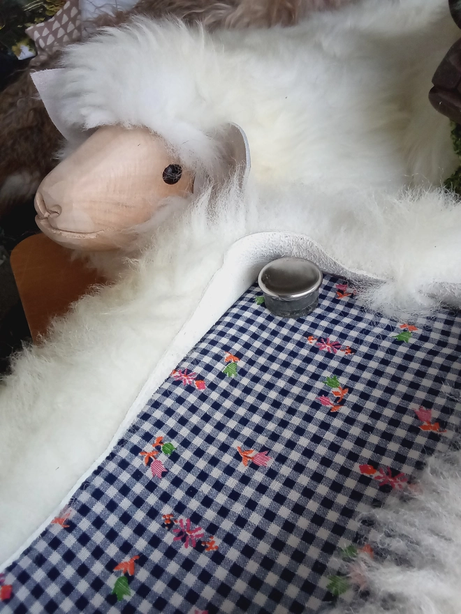 Underside of the footstool showing one of the stainless steel glide feet.