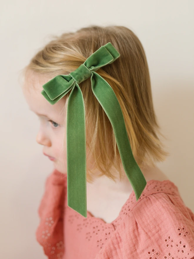 girl in pink dress with beautiful spring green velvet hair bow clip 