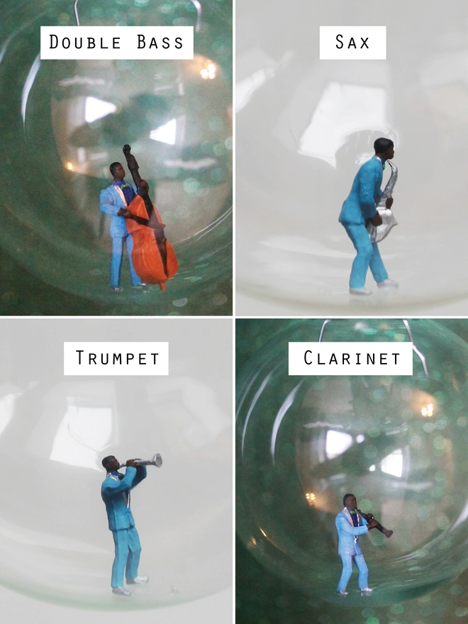 Miniature figures of a jazz double bass player, saxophonist, trumpeter and clarinet player in a christmas bauble 