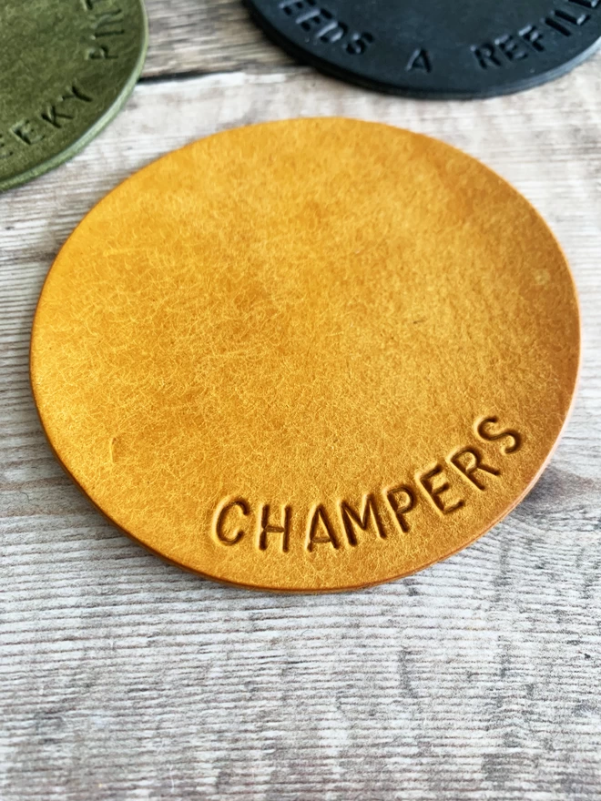 Champers handstamped on a coaster.