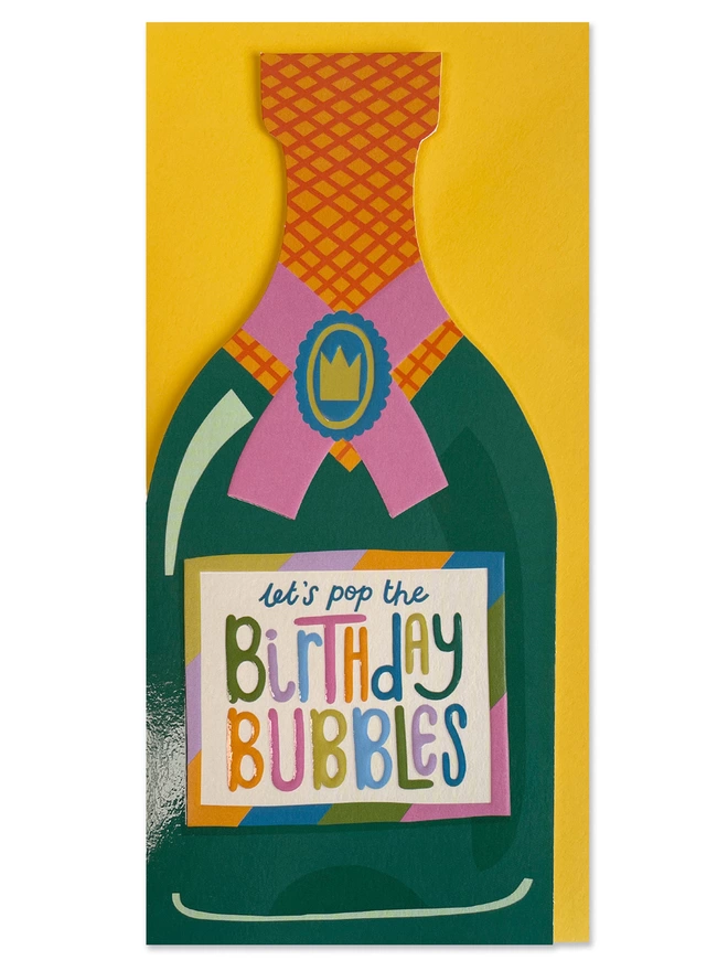 The vibrant Raspberry Blossom ‘Let’s pop the birthday bubbles’ card sits on a sunshine yellow envelope