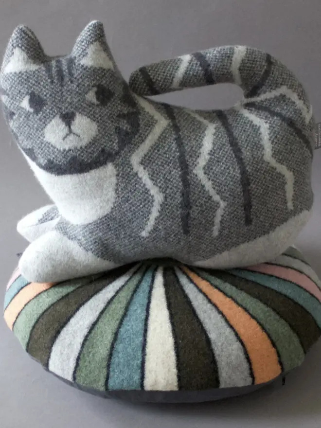 grey tabby cat plush on cushion