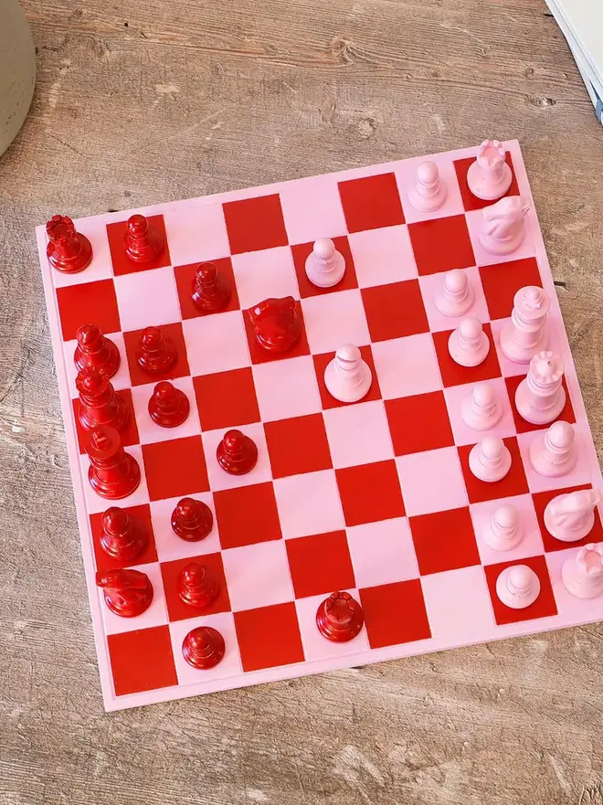 Handmade Jesmonite Chess Board, a handmade colourful chess board sitting on a wooden surface. 
