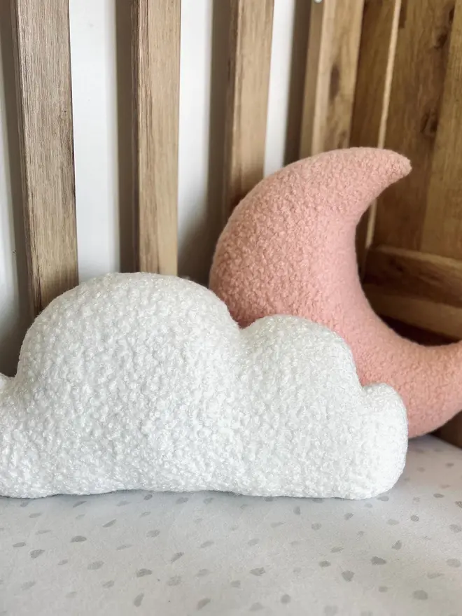 boucle moon and cloud pillow set. a pink moon and white cloud cushion on a sofa.