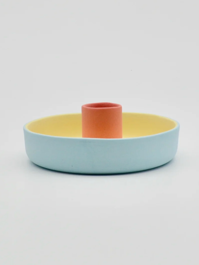 Candle Holder. A blue, yellow and pink candle holder.