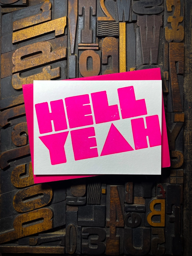 A congratulatory letterpress card using vibrant fluorescent inks the deep impression word HELL YEAH; in bold letters with a set of colourful envelopes. Perfect for exam results and graduations and other celebrations and milestones.