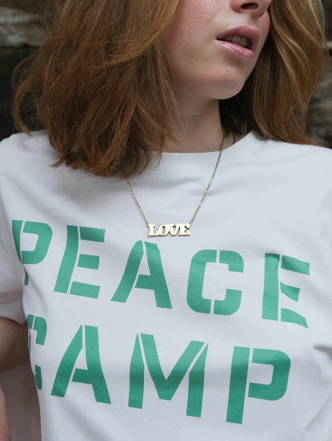 Peace camp t-shirt in white with green print