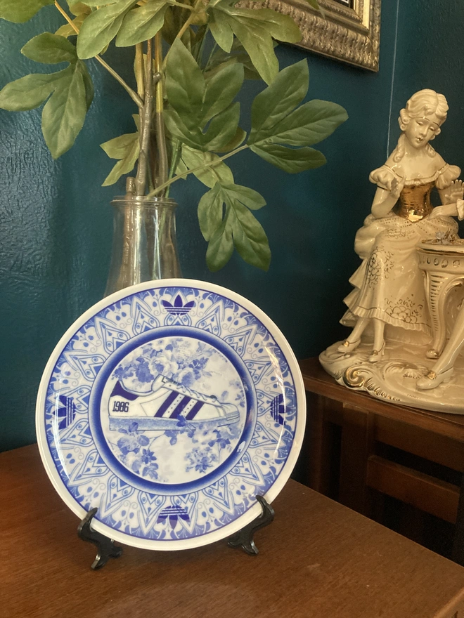 Plate shown on a sideboard utilising the free plate stand provided.