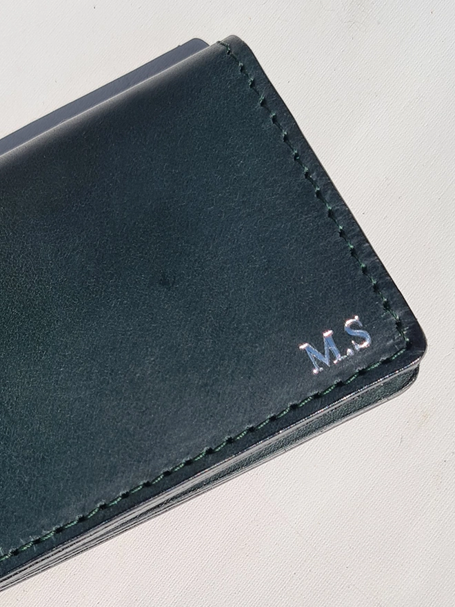 silver embossed initials on a forest green vegetable tanned leather card wallet lined with a original silk war map by Natthakur