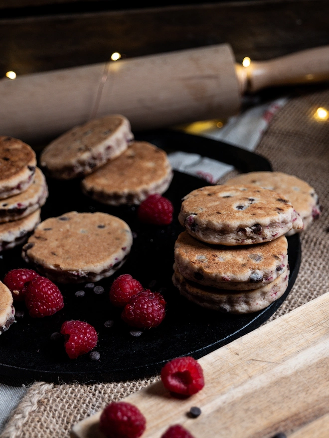 Dark Chocolate & Raspberry on a griddle and wooden board with loose ingredients 