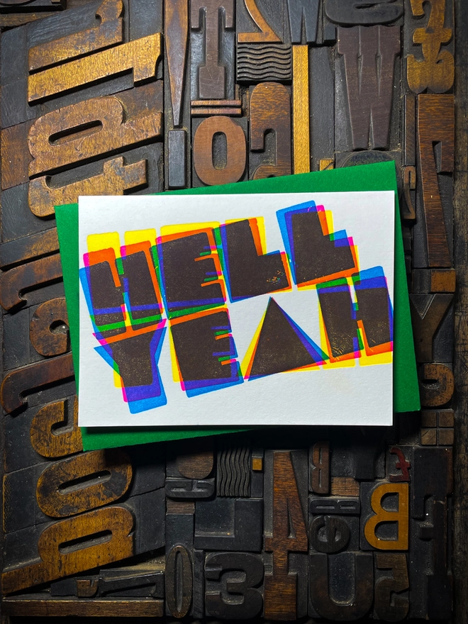 A congratulatory letterpress card using vibrant fluorescent inks the deep impression word HELL YEAH; in bold letters with a set of colourful envelopes. Perfect for exam results and graduations and other celebrations and milestones.