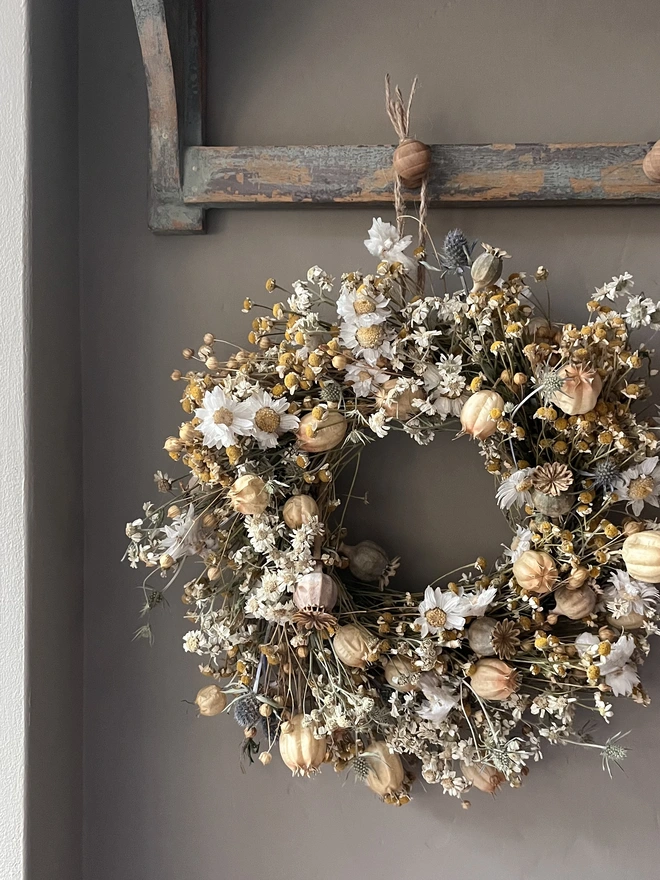 Autumnal Wreath. A wreath made of dried autumnal flowers, hung on a wall.