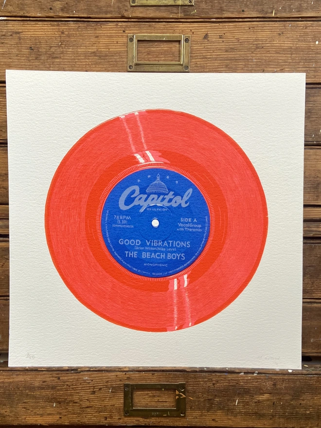 The Beach Boys Good Vibrations red Vinyl Screen Print leaning on a shelf