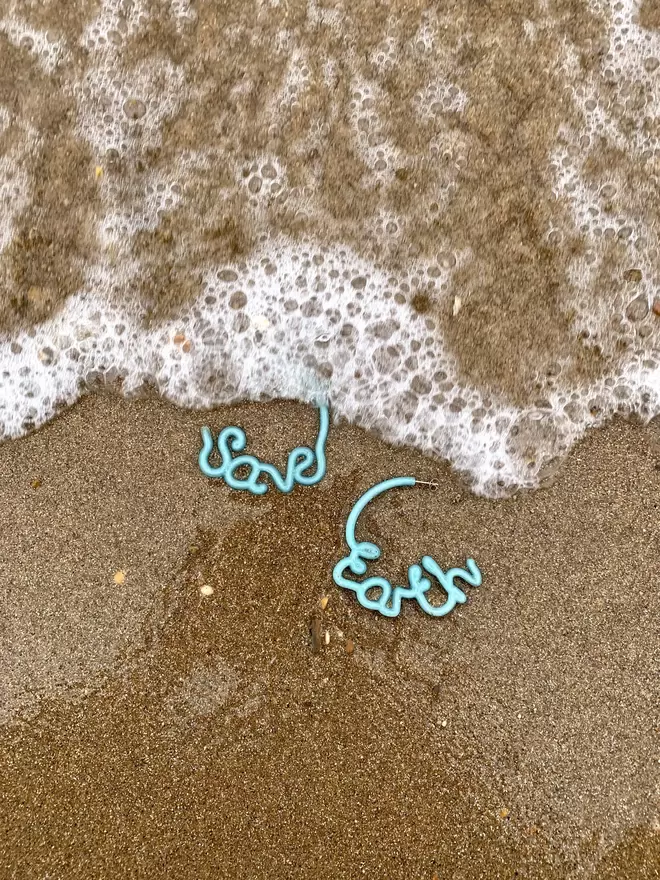 Save Earth hoop earrings made from 100% recycled fishing net, on the beach
