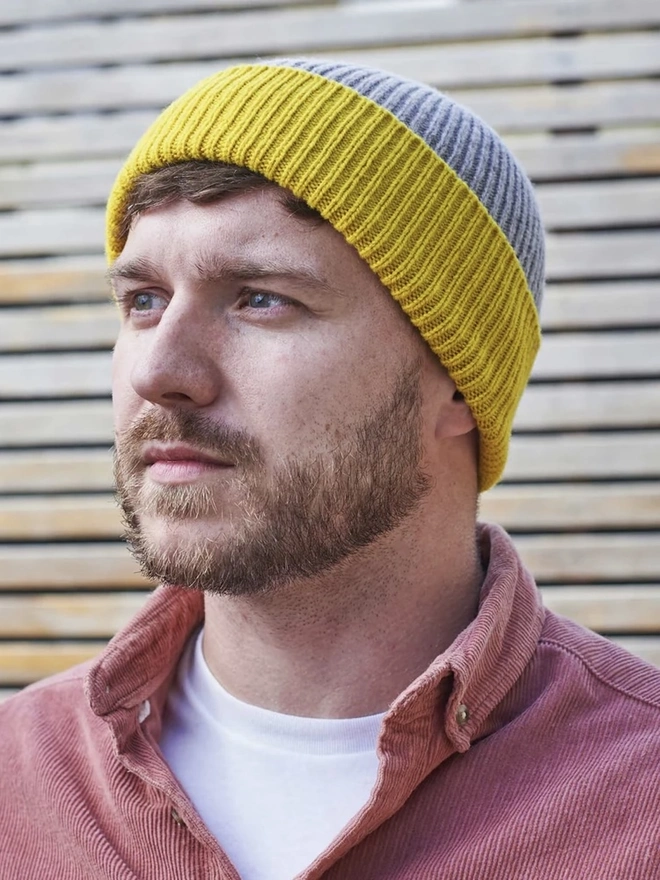 Ribbed Lambswool Unisex Beanie, a person wearing a colourful ribbed beanie outdoors. 