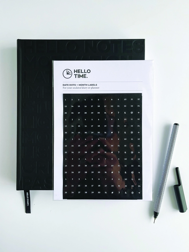 The Hello Time Planner with Undated Diary Sticker Pack laid on top