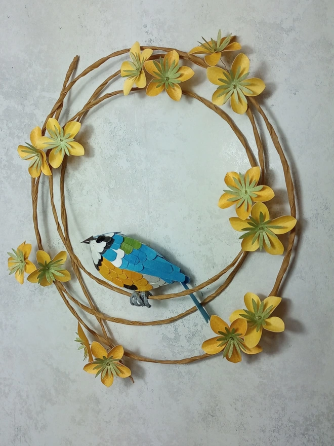 Side view of a blue tit sculpture wall hanging.