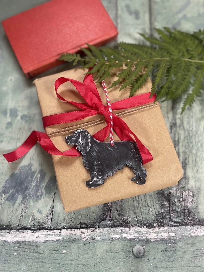 Cocker Spaniel Personalised Christmas Decoration Placed on a gift 