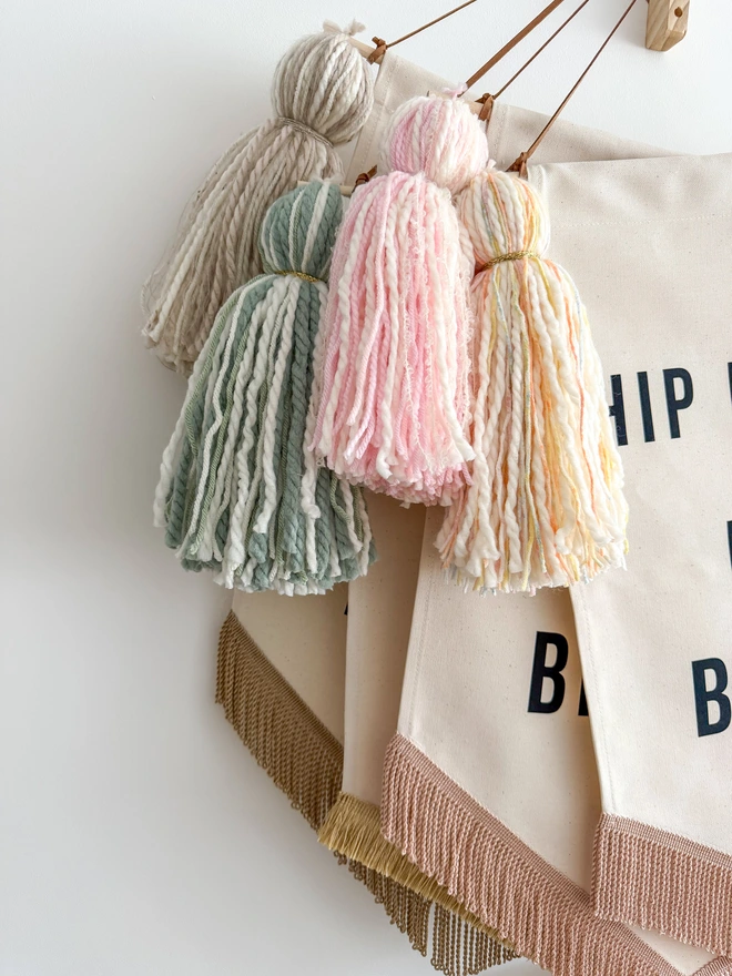 Handmade tassels on birthday banners in pink, green, neutral and multicolour funfetti colours