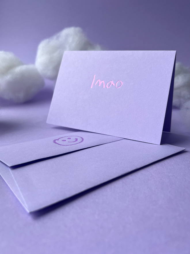 lavender coloured card with lmao  short for 'laugh my ass off' hand foiled in kids hand writing