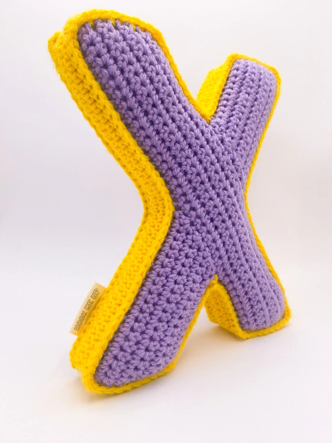 Crochet Cushion shaped like an X in Lilac and Sunshine Yellow
