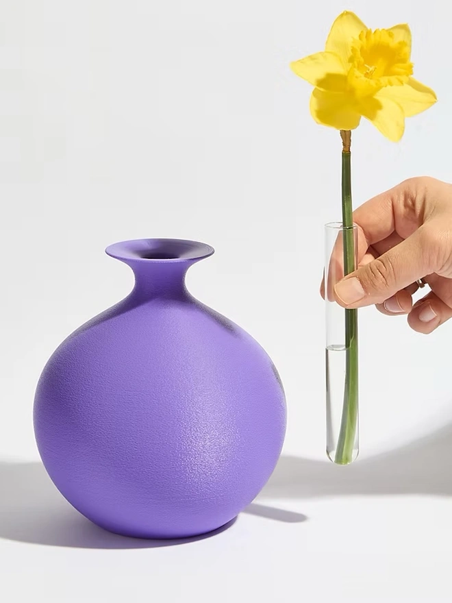 round shaped 3d printed vase in purple with yellow flower