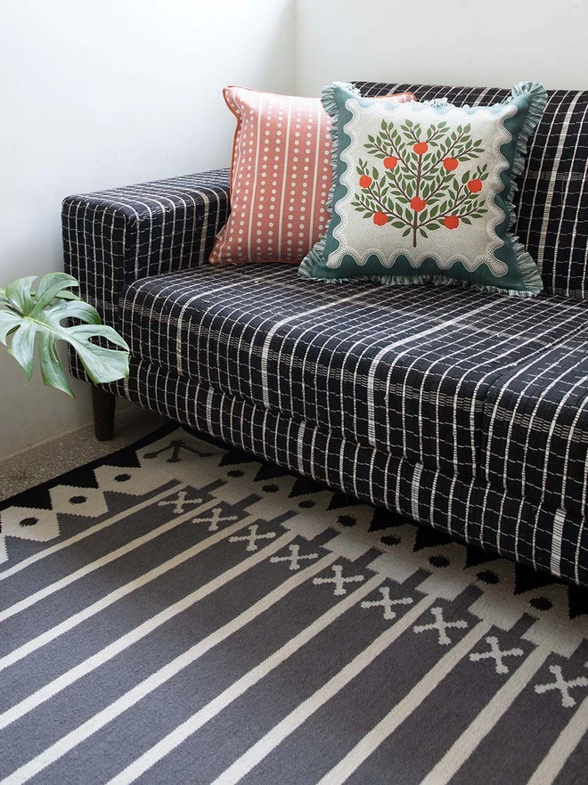 Darjeeling Flatweave Rug, a colourful rug in a living room. It is accompanied by other colourful furniture. 
