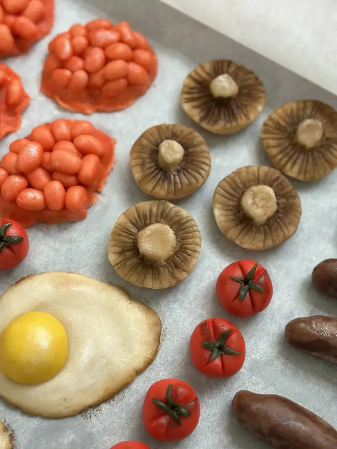 Brekkielicious Marzipan Box, sweet marzipan box displayed on a table surface. In the image are marzipan eggs, beans, mushrooms, tomatoes and sausages. 