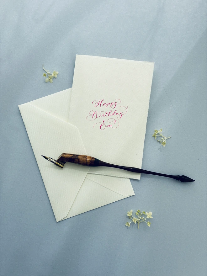 Birthday card with envelope with a calligraphy pen on top