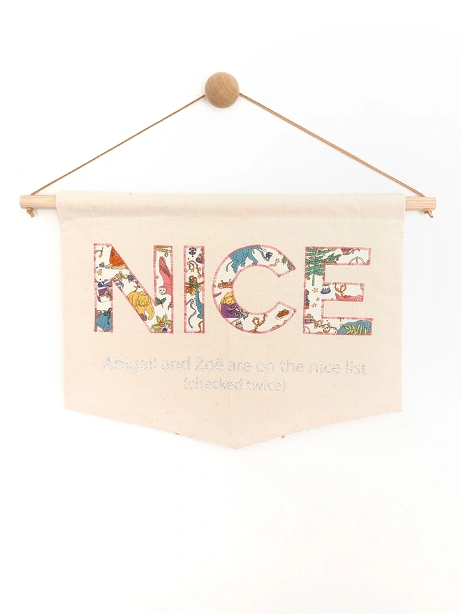 Nice appliqued on a banner in gold glitter fabric, fresh from Santa's nice list