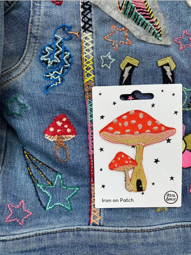 Toadstool embroidered iron on patch on a customised kids denim jacket.